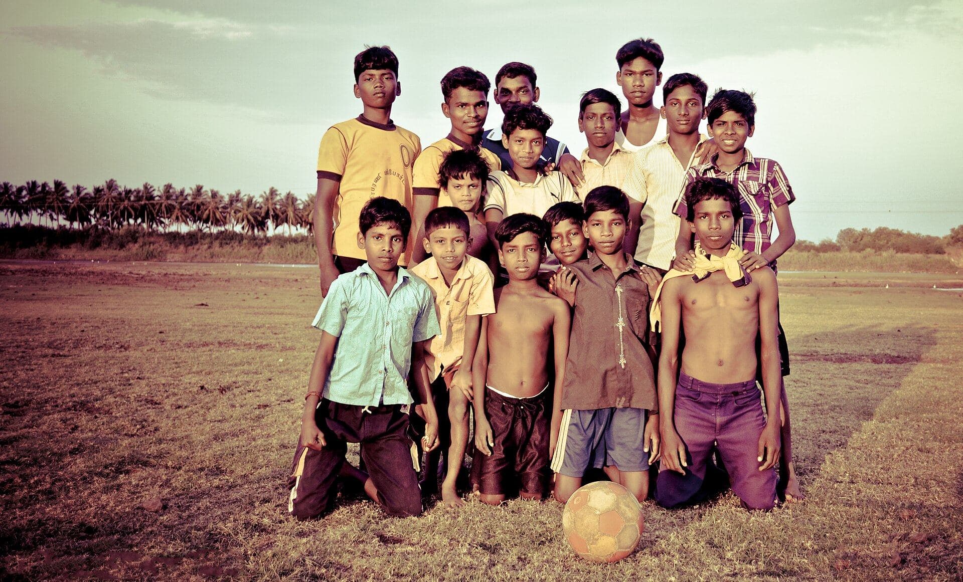 A village football team posing with their ball